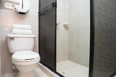 a bathroom with a toilet and a shower at Hotel Puerto Colombia in Puerto Colombia