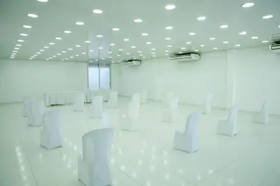a white room with white chairs in it at Hotel Puerto Colombia in Puerto Colombia