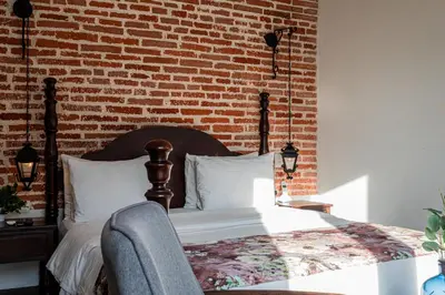 a bedroom with a bed and a brick wall at Soy Local Insignia in Cartagena de Indias