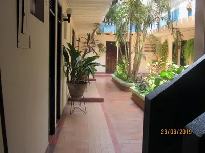 an empty hallway with plants in a building at Hotel Del Mar Inn in Barranquilla