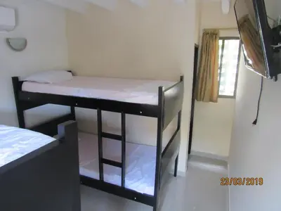 a small room with two bunk beds in it at Hotel Del Mar Inn in Barranquilla