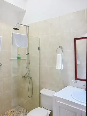 a bathroom with a shower and a toilet and a sink at Casa Digna in Cartagena de Indias