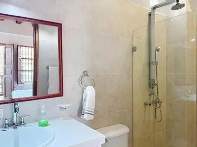 a bathroom with a shower and a toilet and a sink at Casa Digna in Cartagena de Indias