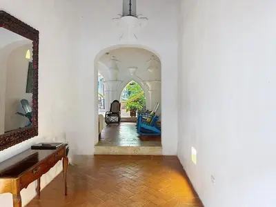 a living room with a mirror and a wooden floor at Casa Digna in Cartagena de Indias