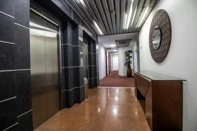 a hallway in a building with a mirror on the ceiling at Atlantic Garden Hotel in Barranquilla