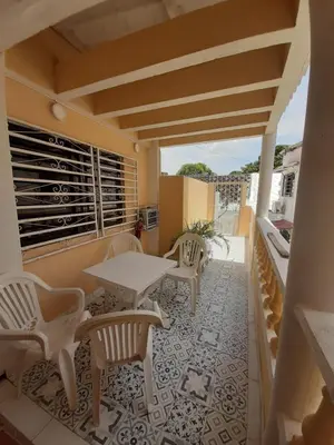 a patio with a table and chairs on a balcony at Casa Francia in Cartagena de Indias