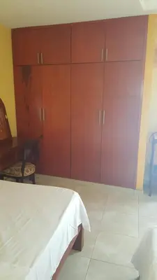 a bedroom with a bed and a desk and cabinets at Casa Francia in Cartagena de Indias