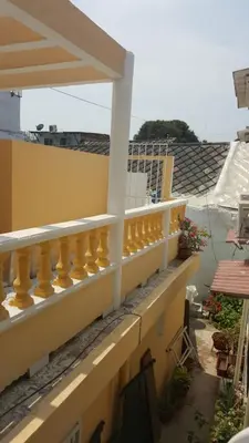 a balcony of a house with a yellow railing at Casa Francia in Cartagena de Indias