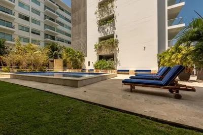 a pair of blue lounge chairs in front of a building at Edificio Morros Vitri Lujo con Panorama in Cartagena de Indias