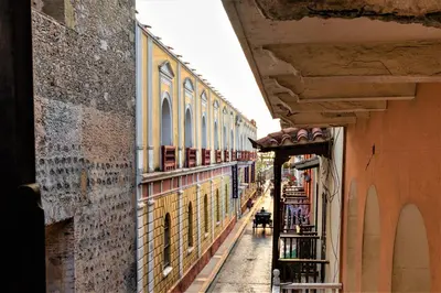 an alley in an old town with buildings at Casa San Pedro - Exclusive 3BR Colonial Apt in Centro Historico by Huespedia in Cartagena de Indias