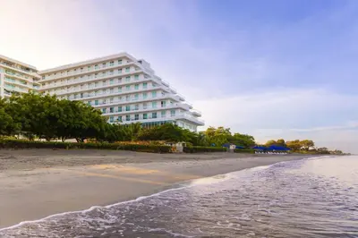 a hotel on the beach next to the ocean at Santa Marta Marriott Resort Playa Dormida in Santa Marta