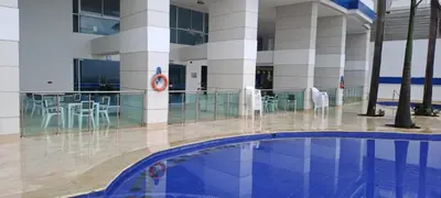 a building with a swimming pool and chairs in it at palmetto frente al mar in Cartagena de Indias