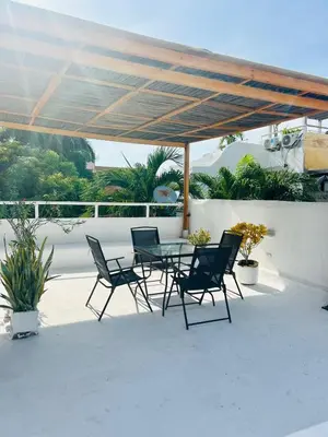 a patio with a table and chairs under a canopy at Calle de la iglesia 35-59 in Cartagena de Indias