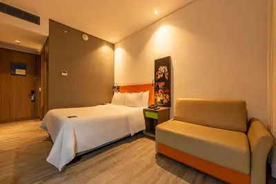 a hotel room with a bed and a chair at Hampton by Hilton Cartagena in Cartagena de Indias
