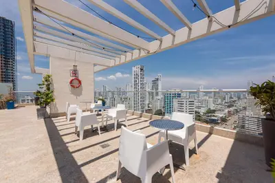 a balcony with a table and chairs and a view of the city at Hampton by Hilton Cartagena in Cartagena de Indias