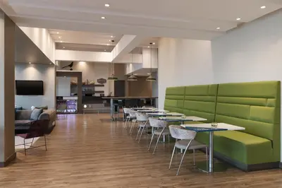 a restaurant with tables and chairs in a room at Hampton by Hilton Cartagena in Cartagena de Indias