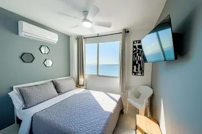 a bedroom with a bed and a tv and a window at Alojamiento con Vista Y Salida al Mar in Cartagena de Indias