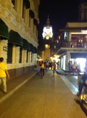 a group of people riding bikes down a street at night at Alojamiento con Vista Y Salida al Mar in Cartagena de Indias