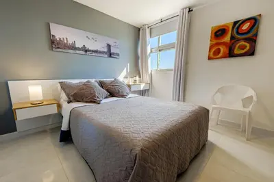 a bedroom with a bed and a table and a chair at Alojamiento con Vista Y Salida al Mar in Cartagena de Indias