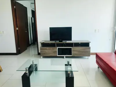 a living room with a tv and a red couch at Cartagena Morros playa edificio frente al mar 1 in Cartagena de Indias