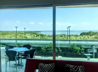a room with a table and chairs and a large window at Cartagena Morros playa edificio frente al mar 1 in Cartagena de Indias