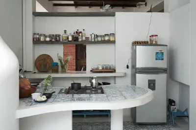 a kitchen with a sink and a refrigerator at Casa Caracola in Tubará