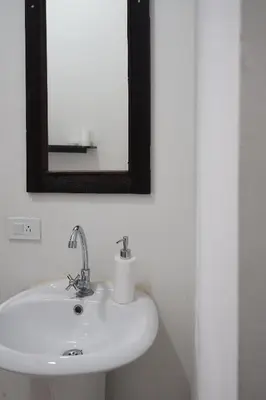 a bathroom with a white sink and a mirror at Casa Caracola in Tubará
