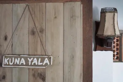 a street light with a sign on a wooden wall at Casa Caracola in Tubará