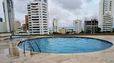 a large swimming pool on top of a building with buildings at Encantador apartamento frente a la playa in Cartagena de Indias