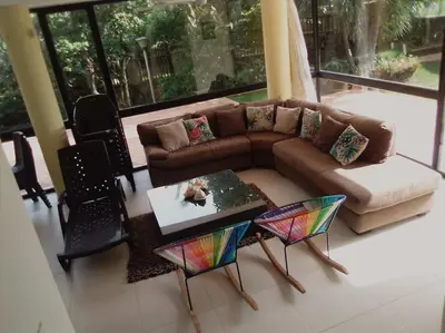 a living room with a couch and a table and chairs at Casa en Santa Veronica Atlantico in Santa Veronica