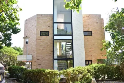 a brick building with glass windows on it at Casa en Santa Veronica Atlantico in Santa Veronica