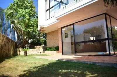 a house with a large glass window in a yard at Casa en Santa Veronica Atlantico in Santa Veronica
