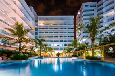 a swimming pool in front of a building at Apartamento en Cartagena primera linea de Playa Morros Epic in Cartagena de Indias