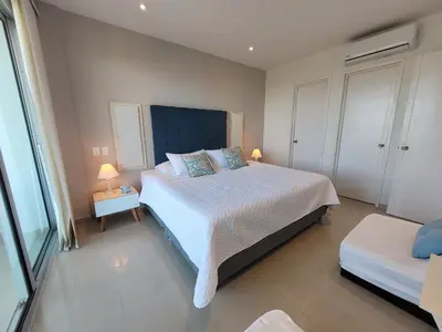 a bedroom with a large bed with two lamps on it at Apartamento en Cartagena primera linea de Playa Morros Epic in Cartagena de Indias
