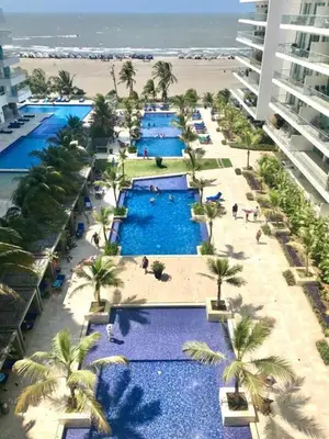 an aerial view of a resort with palm trees and blue pools at Apartamento en Cartagena primera linea de Playa Morros Epic in Cartagena de Indias