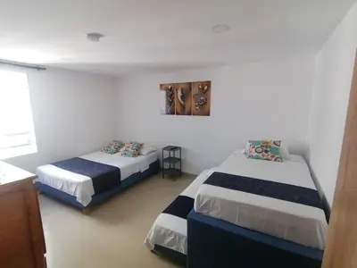 a bedroom with two beds and a window at Ocean blue Ed Conquistador in Cartagena de Indias
