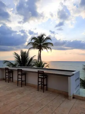 a bar on the beach with a view of the ocean at Hotel Rilux Tolú -Casa Danae- in Tolú