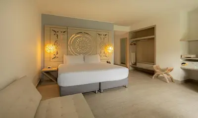 a bedroom with a bed and a desk in it at Grand Sirenis Cartagena in Cartagena de Indias