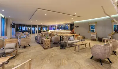 a lobby with chairs and tables and a salon at Grand Sirenis Cartagena in Cartagena de Indias