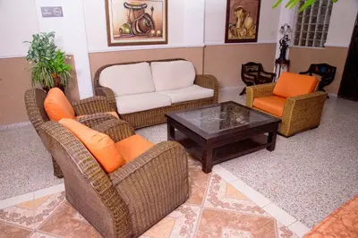 a living room with wicker chairs and a coffee table at Ayenda 1309 Villa Dilia in Barranquilla