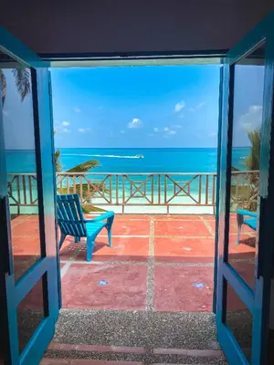a view of the ocean from a patio with a bench at Casa Tinti in Tintipan Island
