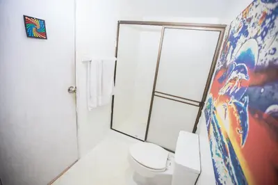 a bathroom with a toilet and a shower at Apt frente al Mar 10 min a pie Centro Histórico in Cartagena de Indias
