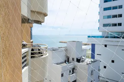 a view of the ocean from a balcony of a building at Apt frente al Mar 10 min a pie Centro Histórico in Cartagena de Indias
