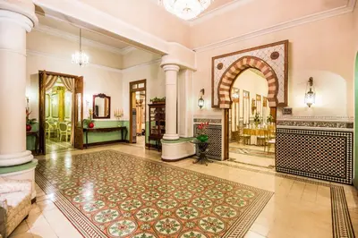 an ornate lobby with a fireplace and an entry way at Hotel Majestic in Barranquilla