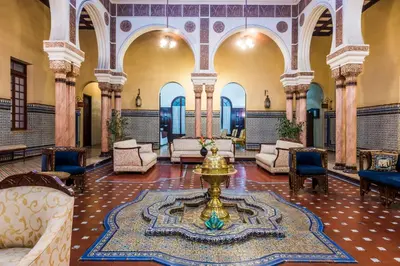 a lobby with a fountain in the middle of a room at Hotel Majestic in Barranquilla