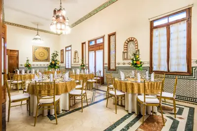 a conference room with tables and chairs and a chandelier at Hotel Majestic in Barranquilla