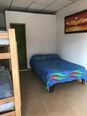 a bedroom with a bed and a bunk bed at Cabaña La Fortaleza in Tolú