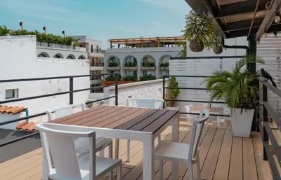 a wooden table and chairs on a balcony at Casa Amanzi Cartagena by Bernalo Hotels in Cartagena de Indias