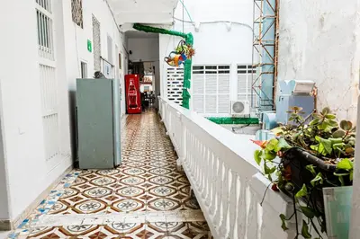 an alley with a tile floor in a building at Hostal Badillo SV in Cartagena de Indias