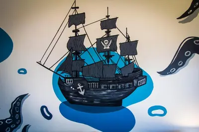 a drawing of a pirate ship on the wall at Casa del Puerto Hostel & Suites in Cartagena de Indias